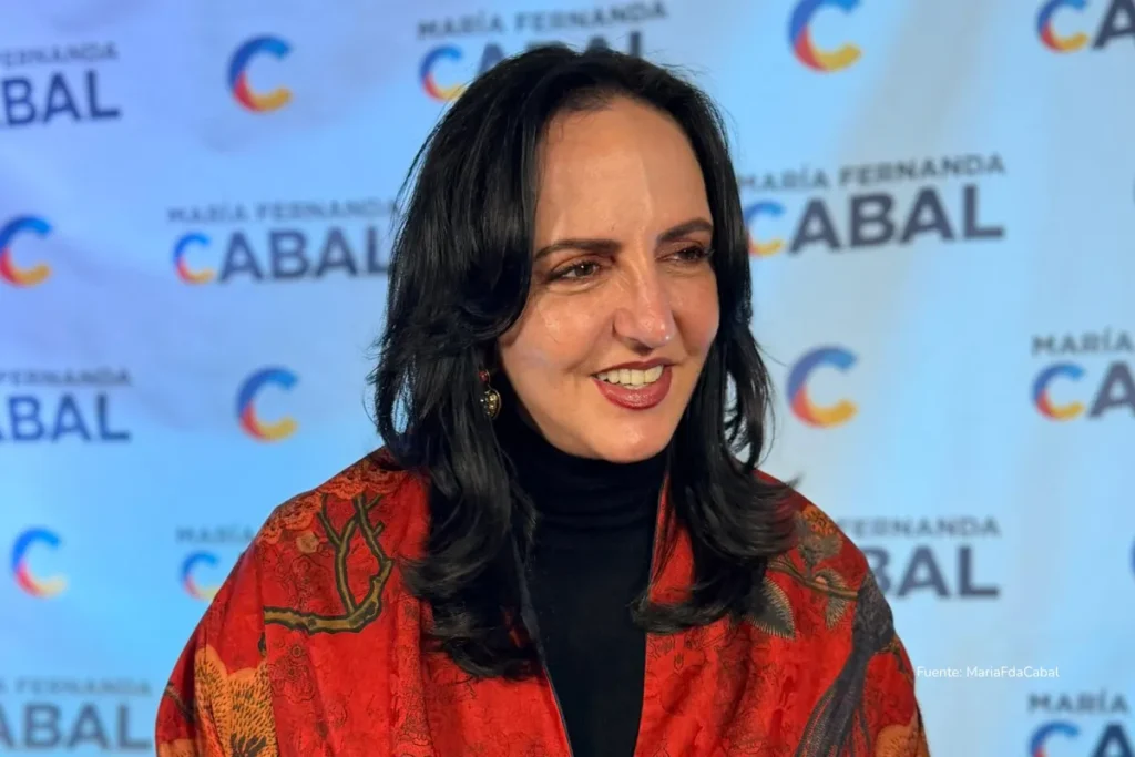 El hijo de José Félix Lafaurie y María Fernanda Cabal habría recibido subsidio de Finagro como “pequeño productor” 3 Mujer sonríe durante un evento político frente a un fondo con logotipos de campaña.