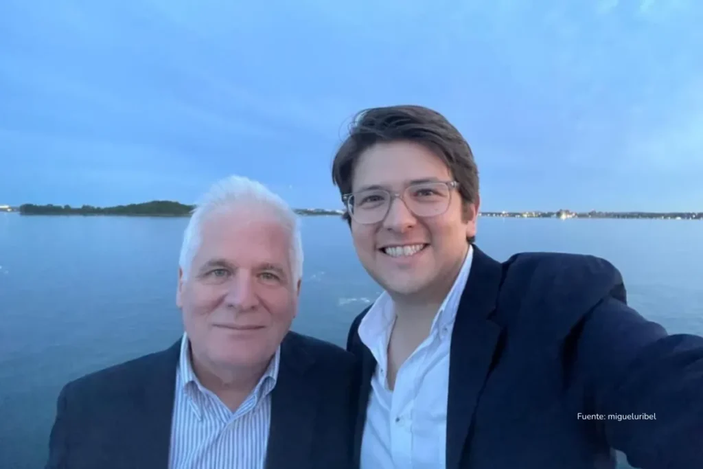 La derecha marcha hacia las elecciones 2026 sin liderazgo único 4 Dos hombres sonríen para una foto tipo selfi en un muelle, con un lago o mar al fondo durante el atardecer.