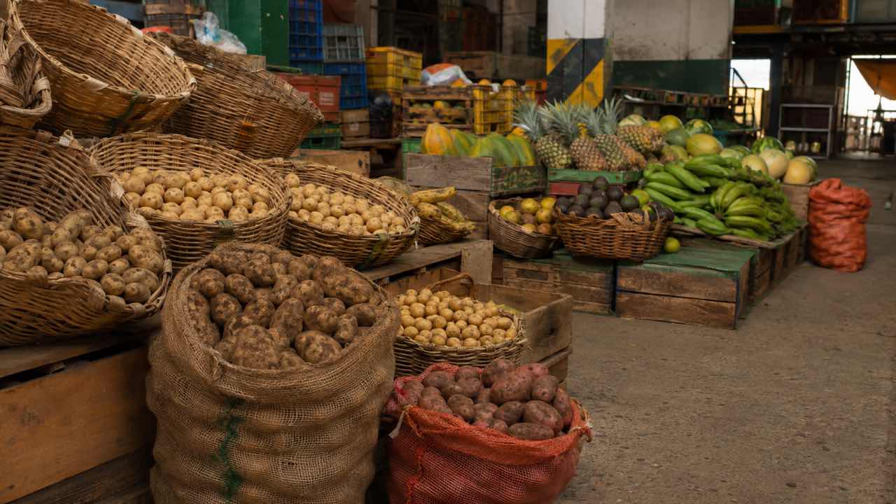 El DANE midió la inflación anual en 6,24 % en agosto: los hogares de mayores ingresos enfrentan 6,39 % y los de menores, 5,98 % 1 Puesto de papas y frutas en una plaza de mercado colombiana al final de la jornada