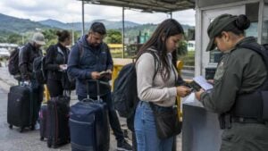 Viajeros revisan documentos y equipaje en un punto fronterizo